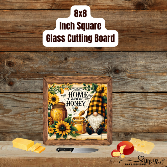 Home Is Where My Honey™ — 8×8 Glass Cutting Board (Sunflower Gnome)