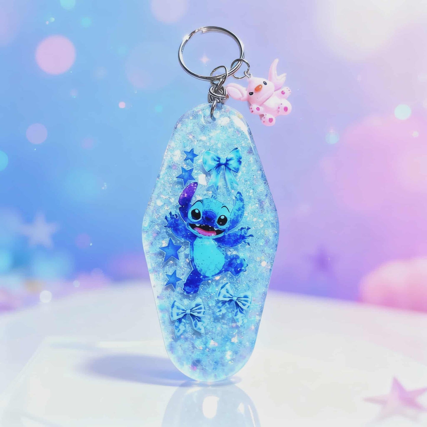 🌌 Blue Glitter Stitch Resin Keychain – Handmade Sparkle Charm with Star & Bow Details 🌌
